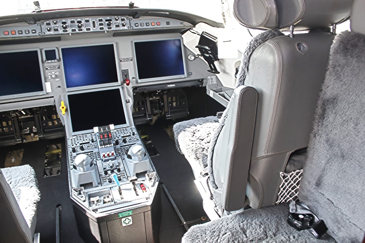 Flynia cabin service — flight attendant serving passengers